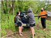 Volunteers Throwing Trash Into the Back of a Truck